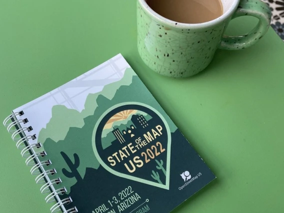 State of the Map printed program and cup of coffee