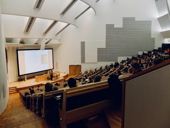 Photo of a lecture hall with instructor and students