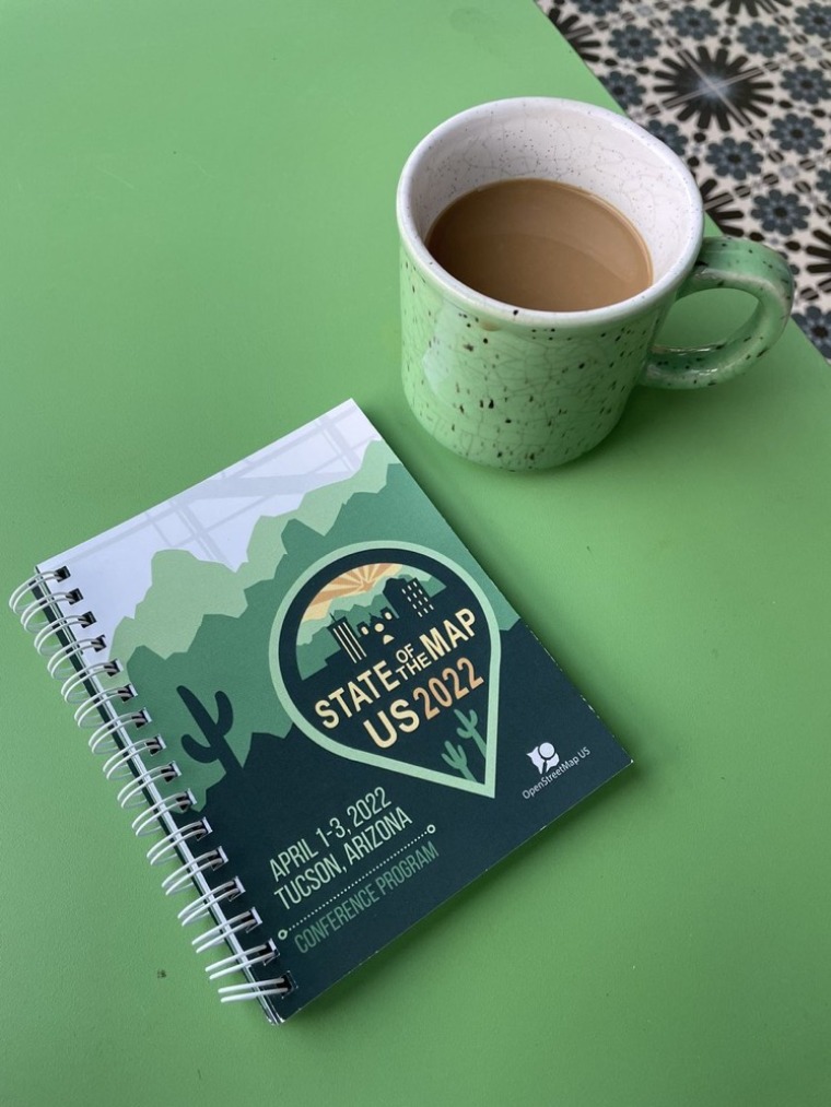 State of the Map printed program and cup of coffee